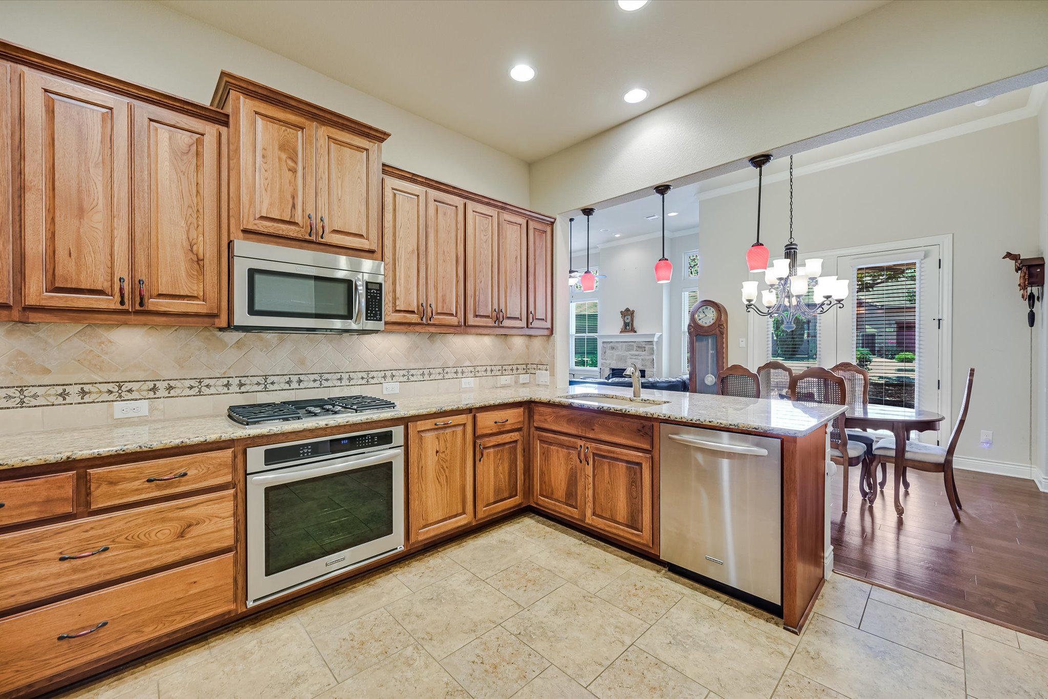 103 Rivalto Circle, Unit 1 Lakeway, TX 78734 - Photo 9 of 34 Kitchen with granite counters and tile floor