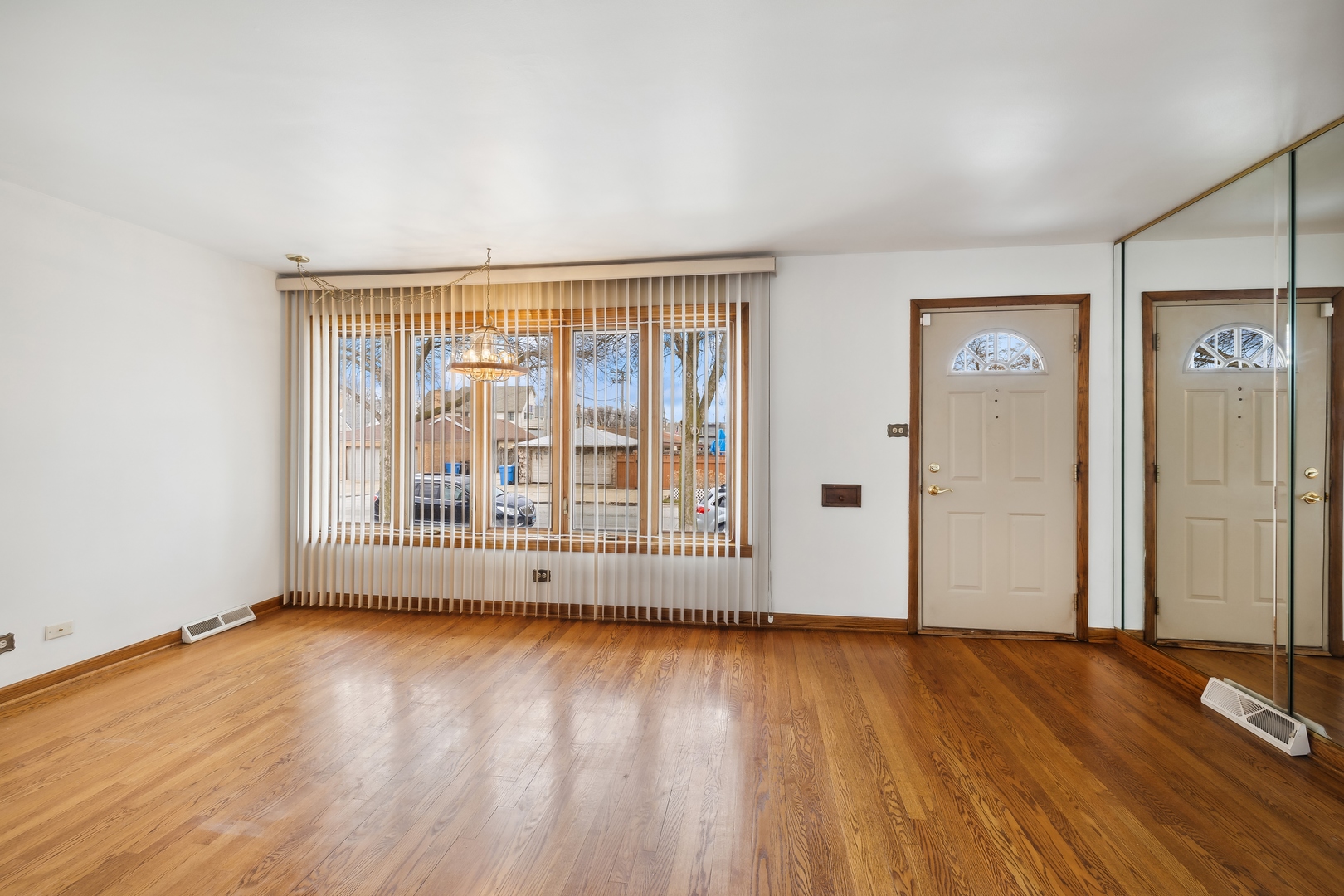 6741 West 59th Street Chicago, IL 60638 - Photo 5 of 16 an empty room with wooden floor and windows