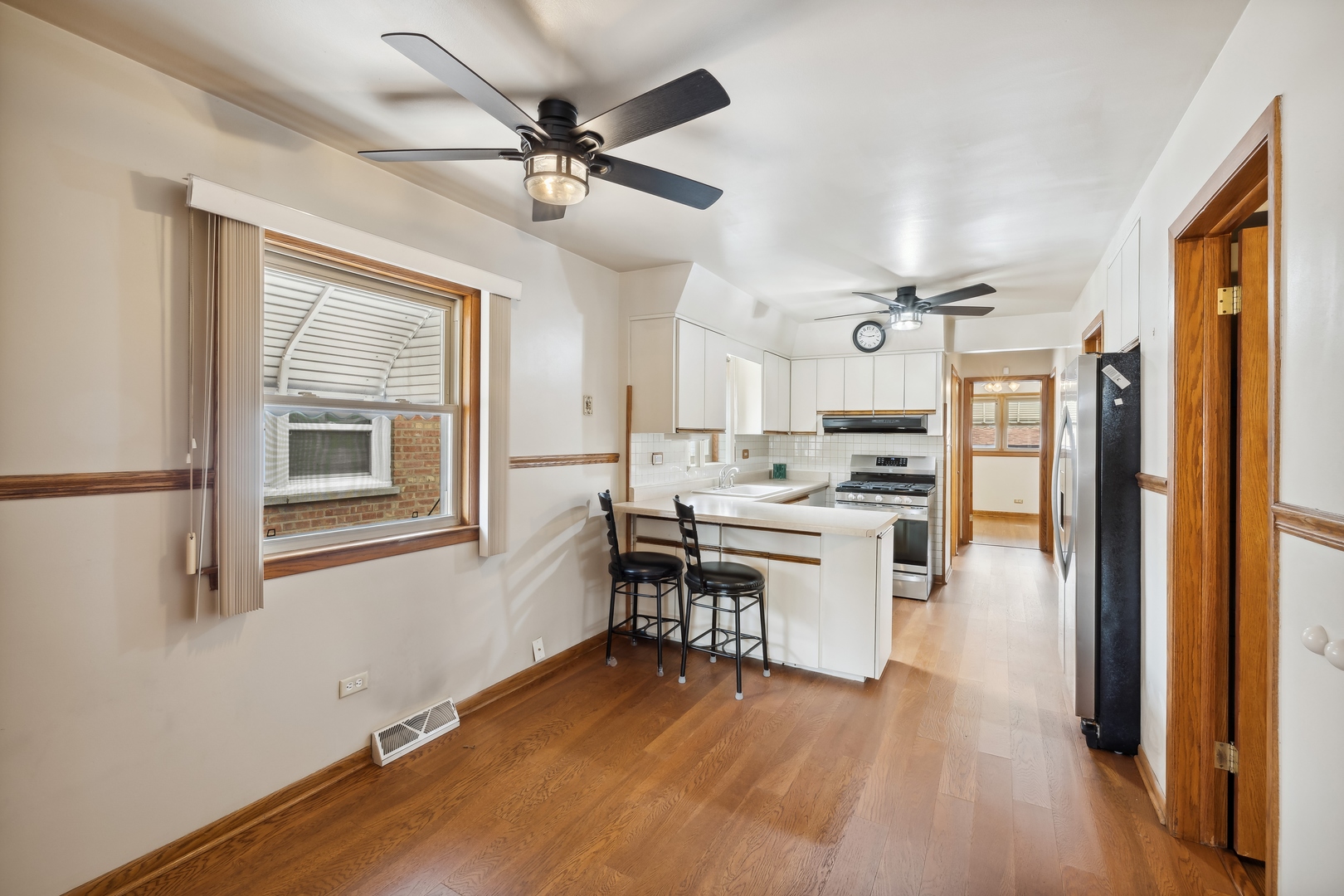 6741 West 59th Street Chicago, IL 60638 - Photo 6 of 16 a kitchen with a refrigerator a sink and dishwasher with wooden floor