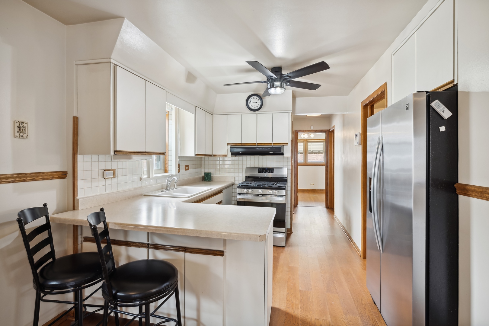 6741 West 59th Street Chicago, IL 60638 - Photo 7 of 16 a kitchen with a table chairs refrigerator and cabinets