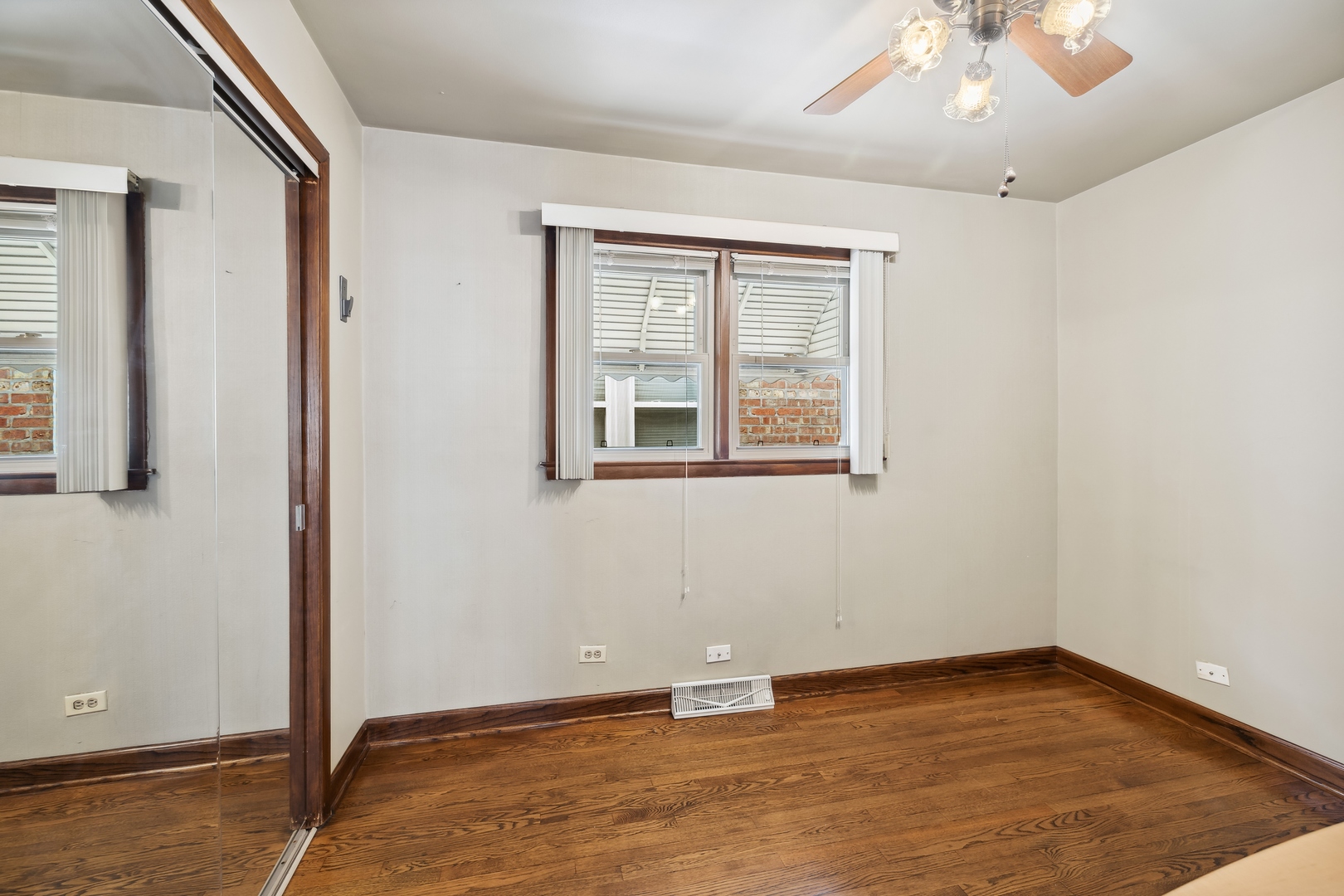 6741 West 59th Street Chicago, IL 60638 - Photo 9 of 16 an empty room with wooden floor and windows
