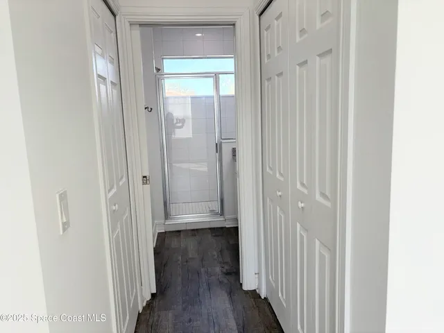 a bathroom with a granite countertop shower and a sink