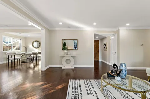 a living room with furniture kitchen and a wooden floor