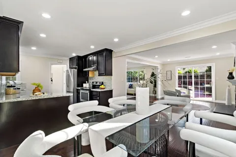 a kitchen with stainless steel appliances granite countertop wooden cabinets a stove top oven a sink and dishwasher