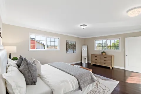 a bedroom with a bed and a large window