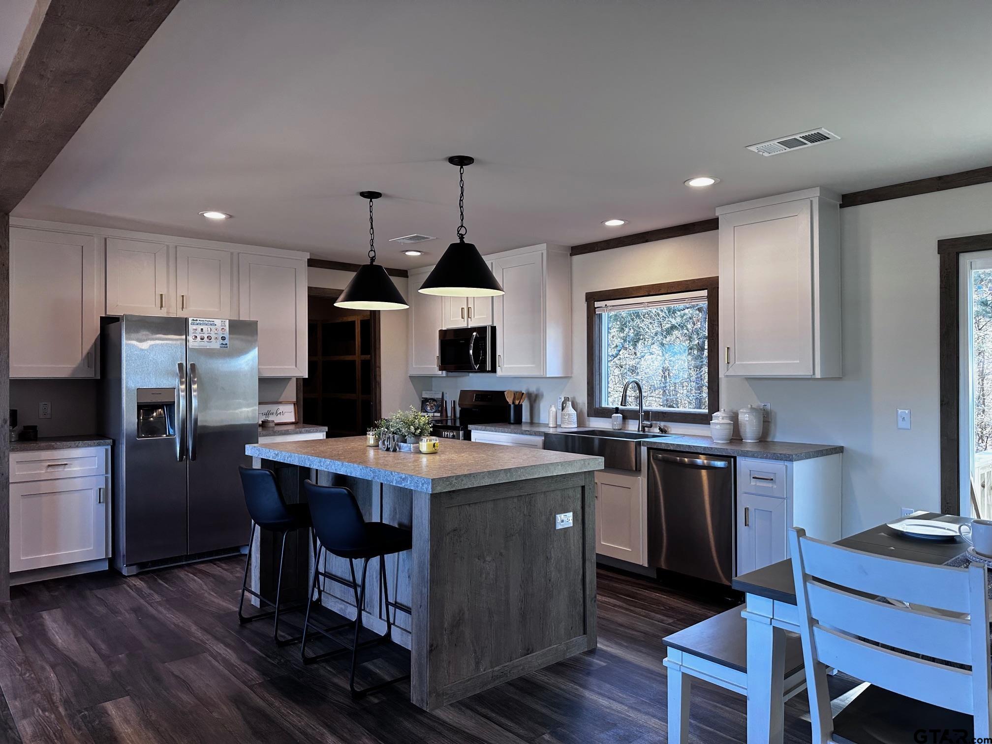 118 Private Road 5296 Alba, TX 75410 - Photo 4 of 25 a kitchen with refrigerator cabinets and wooden floor