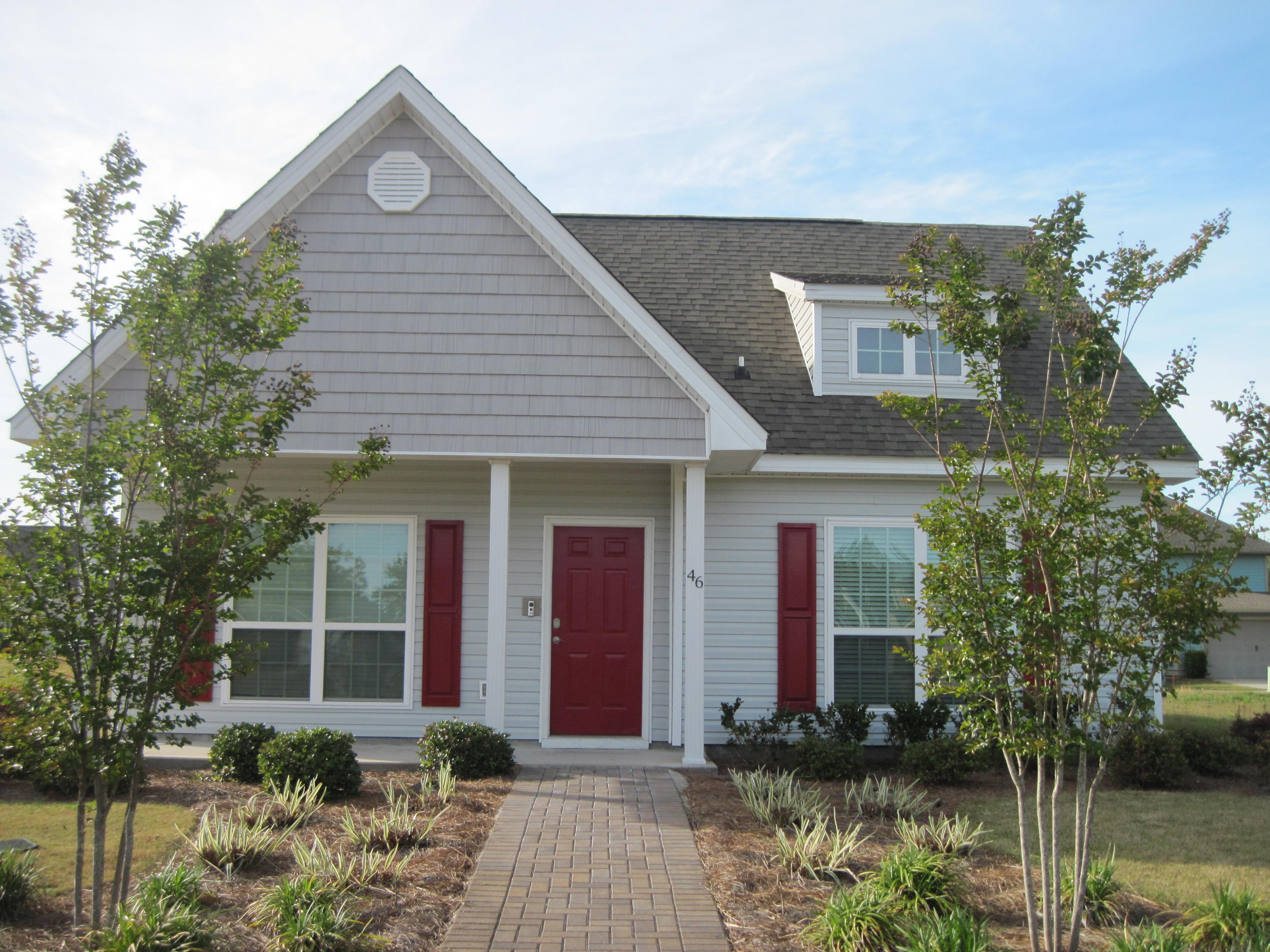 46 Nelly Street Freeport, FL 32439 - Photo 1 of 16 a front view of a house with garden