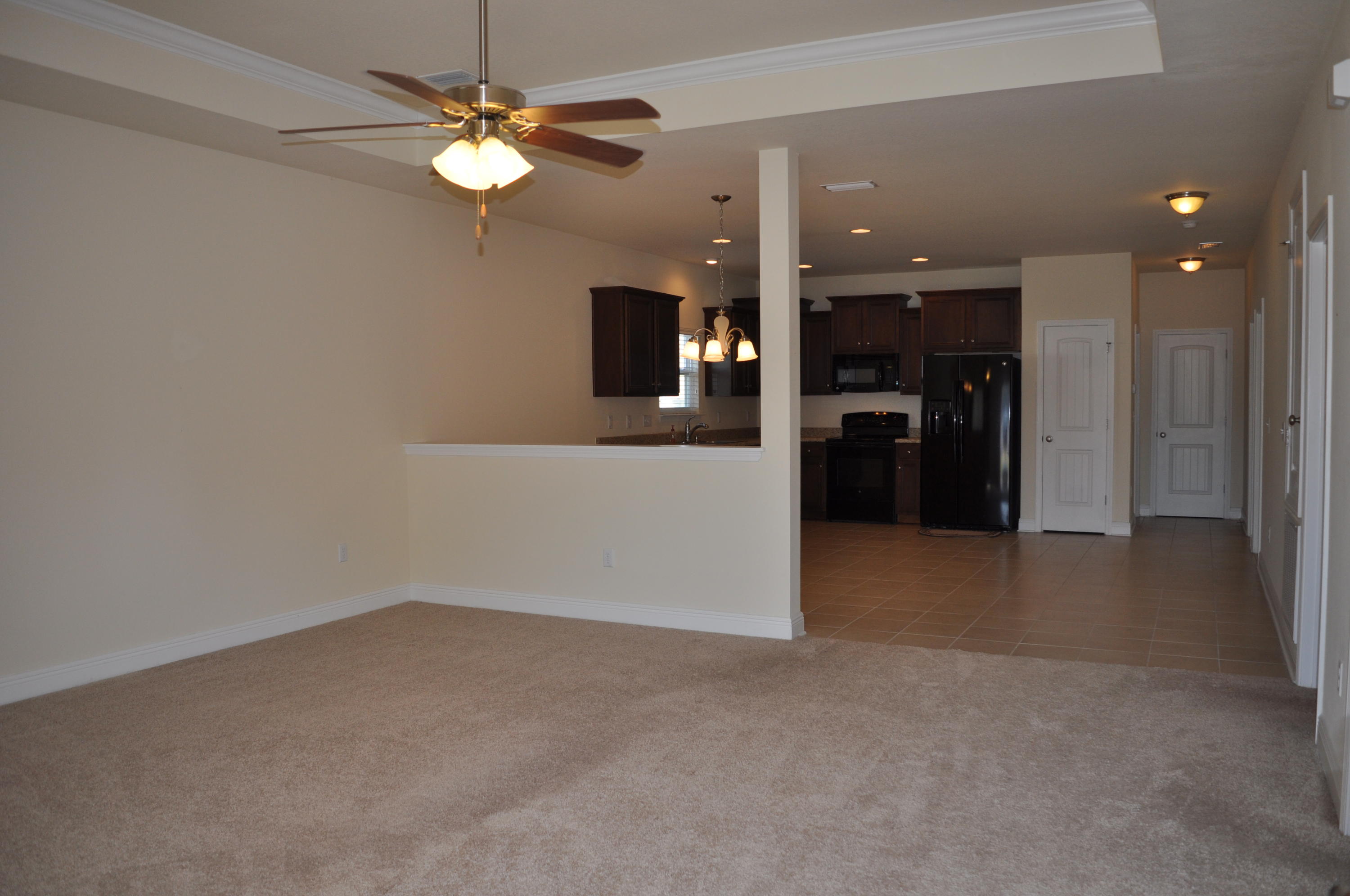 46 Nelly Street Freeport, FL 32439 - Photo 2 of 16 wooden floor in an empty room with a kitchen