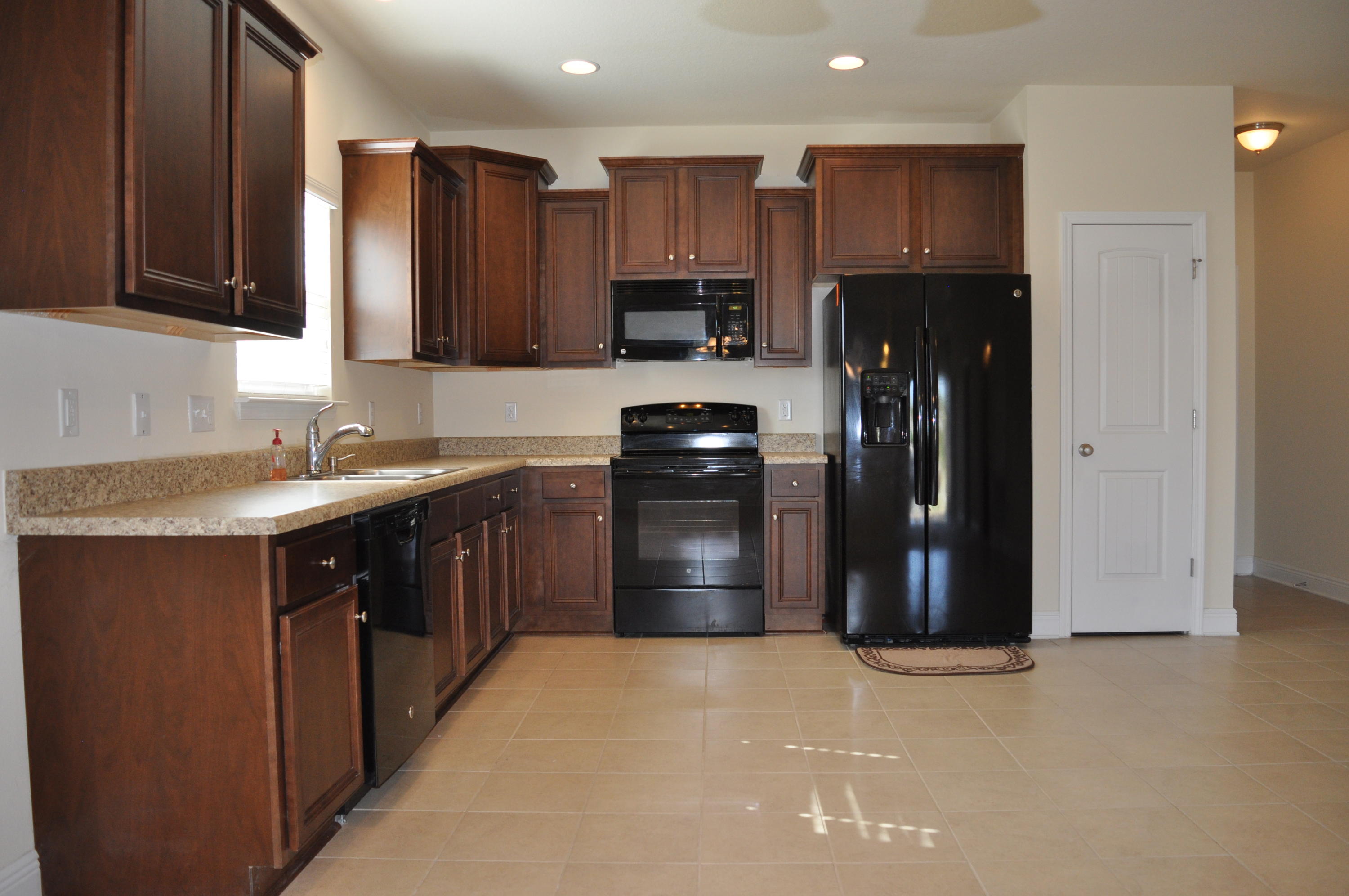 46 Nelly Street Freeport, FL 32439 - Photo 5 of 16 a kitchen with stainless steel appliances granite countertop a refrigerator and a sink