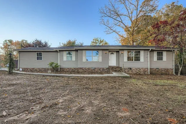 a front view of house with yard and trees