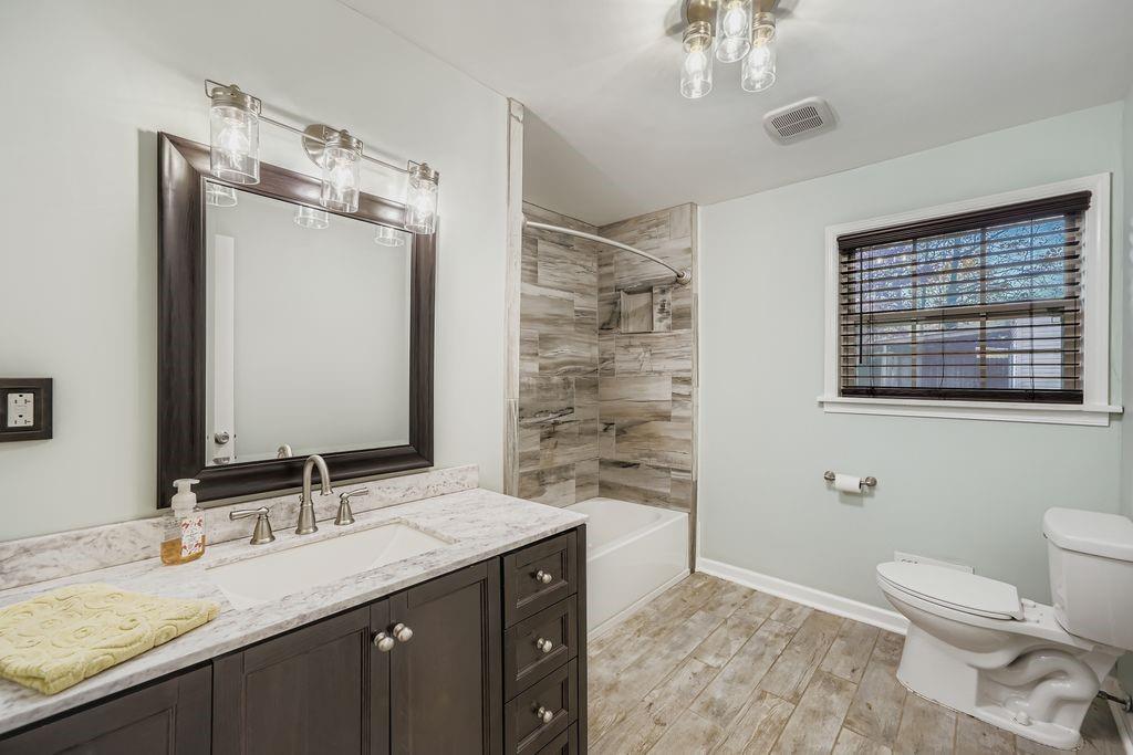 6431 Courtney Drive Winston, GA 30187 - Photo 17 of 22 a bathroom with a granite countertop sink toilet and shower