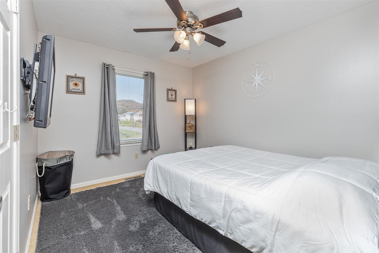 160 Buckboard Road Waynesboro, VA 22980 - Photo 19 of 34 a bedroom with a bed and a chandelier