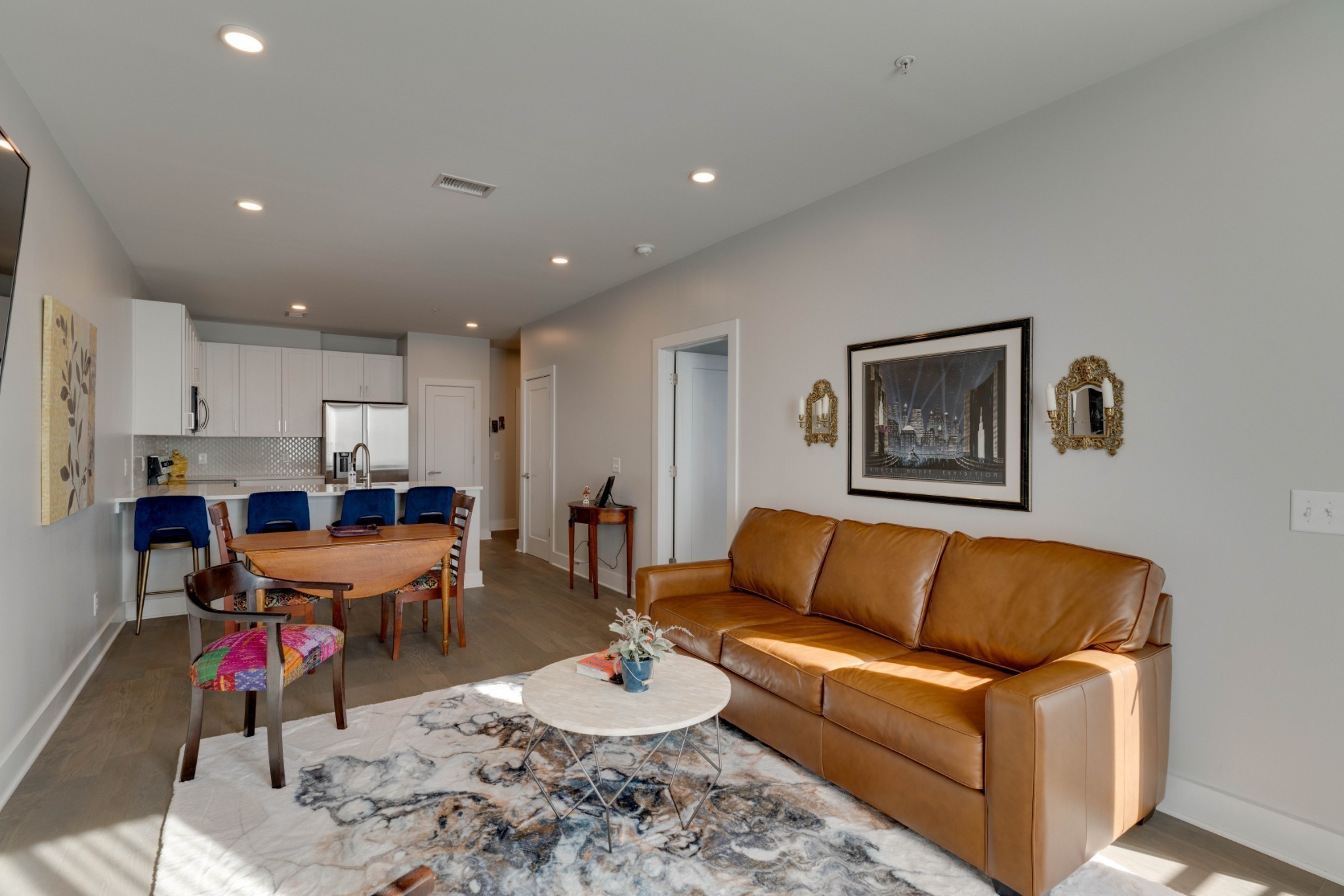 a living room with furniture and kitchen view