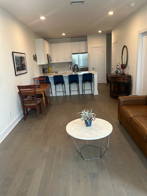 1041 East Trinity Lane, Unit 315 Nashville, TN 37216 - Photo 8 of 48 a living room with furniture a table and kitchen view