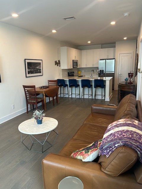 1041 East Trinity Lane, Unit 315 Nashville, TN 37216 - Photo 9 of 48 a living room with furniture and kitchen view
