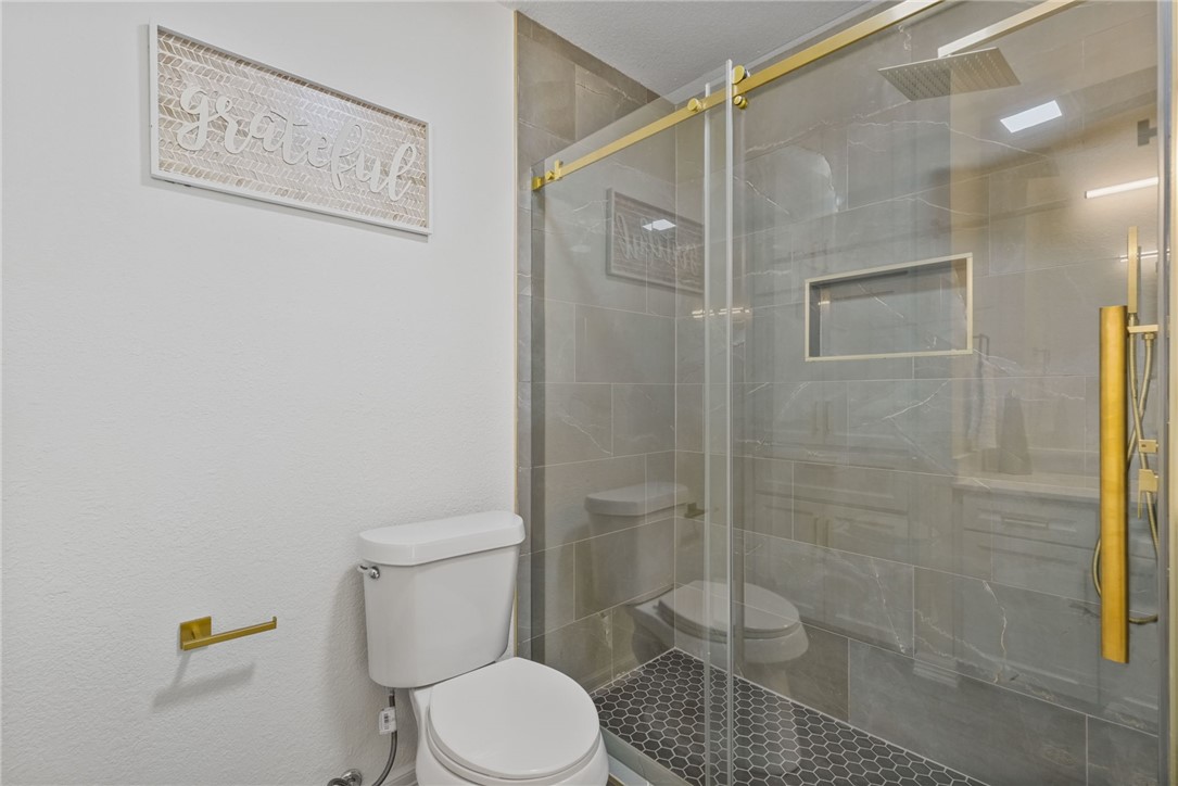 5409 Timbergate Drive Corpus Christi, TX 78413 - Photo 20 of 29 a white toilet sitting next to a bathroom shower