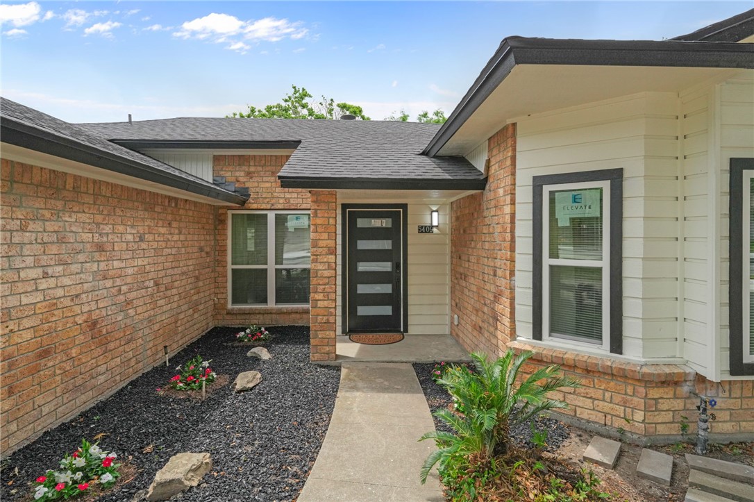 5409 Timbergate Drive Corpus Christi, TX 78413 - Photo 2 of 29 a front view of a house with a blue gate