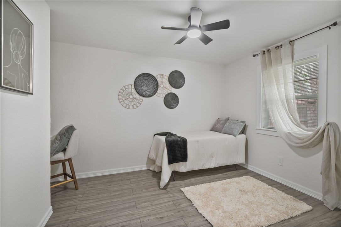 5409 Timbergate Drive Corpus Christi, TX 78413 - Photo 22 of 29 a bedroom with a bed and a chandelier