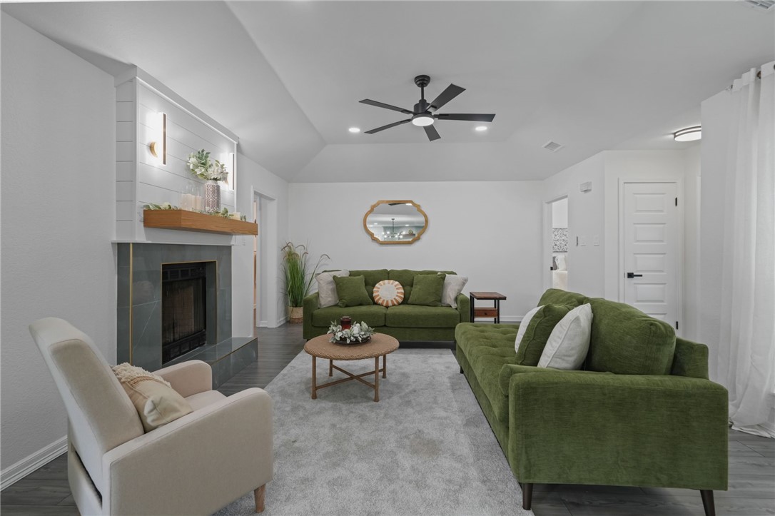 5409 Timbergate Drive Corpus Christi, TX 78413 - Photo 6 of 29 a living room with furniture a rug and a fireplace