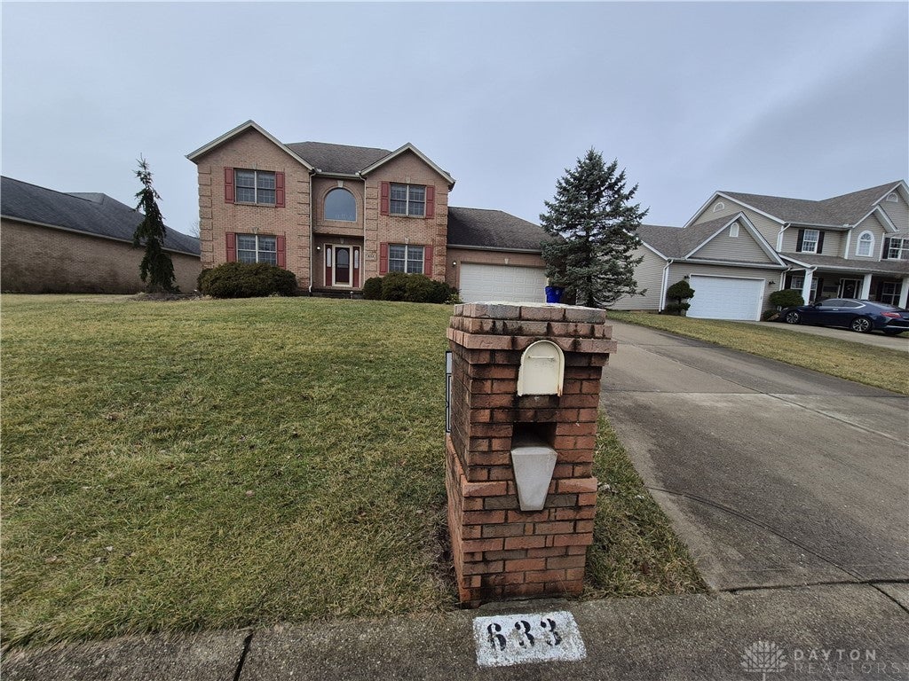 This classic brick residence presents a welcoming facade with traditional architectural elements.