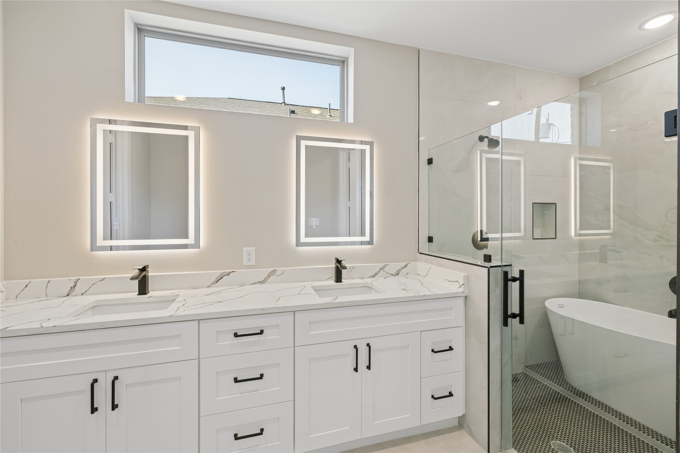 20019 Venetto St Spring Spring, TX 77388 - Photo 15 of 35 a bathroom with double vanity sink a mirror and a bathtub