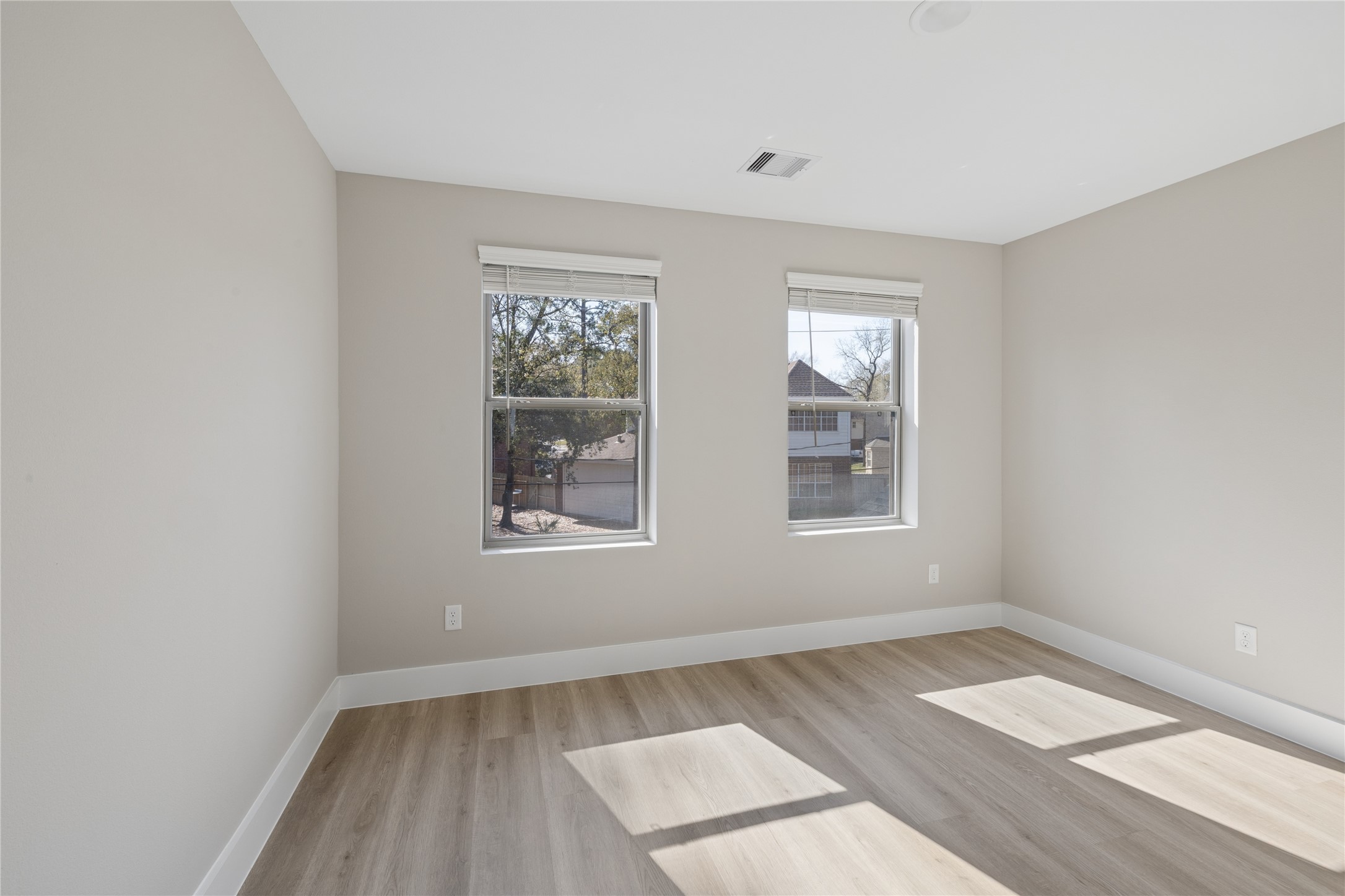 20019 Venetto St Spring Spring, TX 77388 - Photo 23 of 35 an empty room with wooden floor and windows