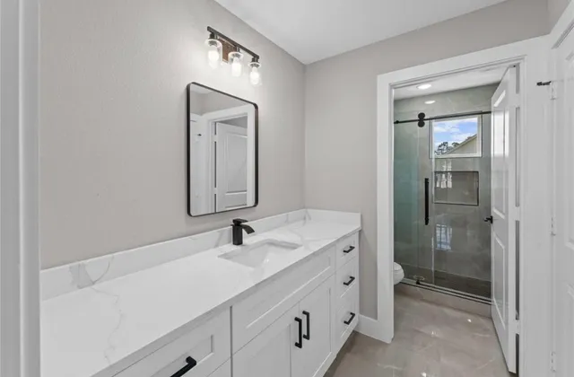 a bathroom with a double vanity sink mirror and