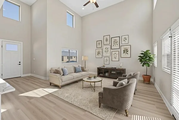 a living room with furniture and wooden floor