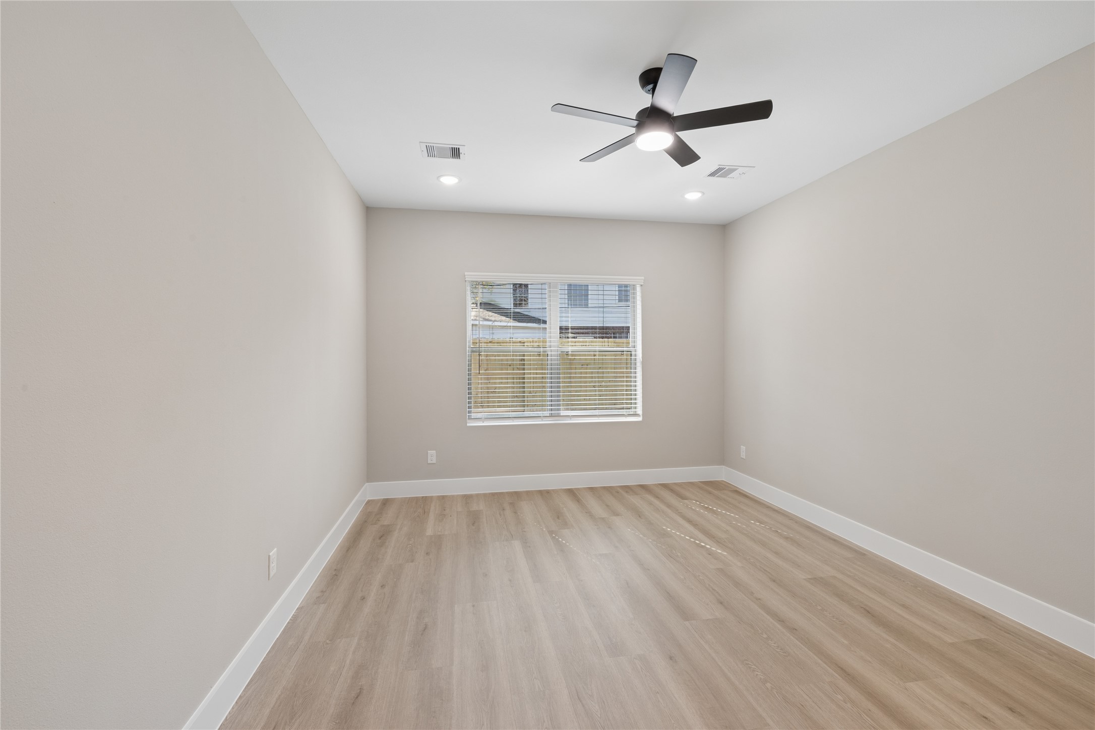 20019 Venetto St Spring Spring, TX 77388 - Photo 10 of 35 wooden floor in an empty room with a window