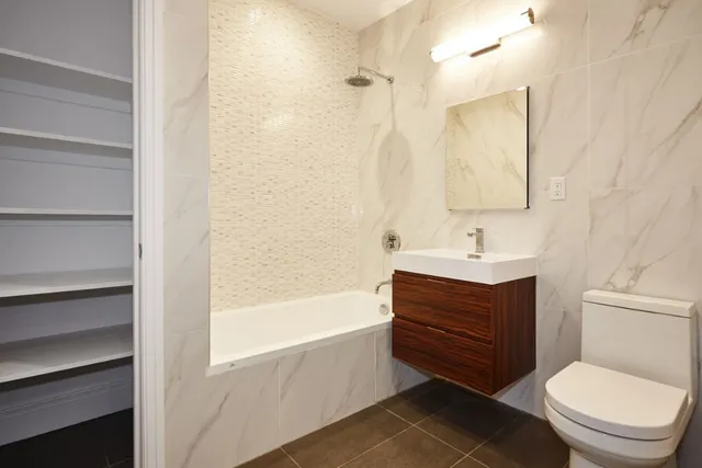 a bathroom with a sink a toilet and bathtub