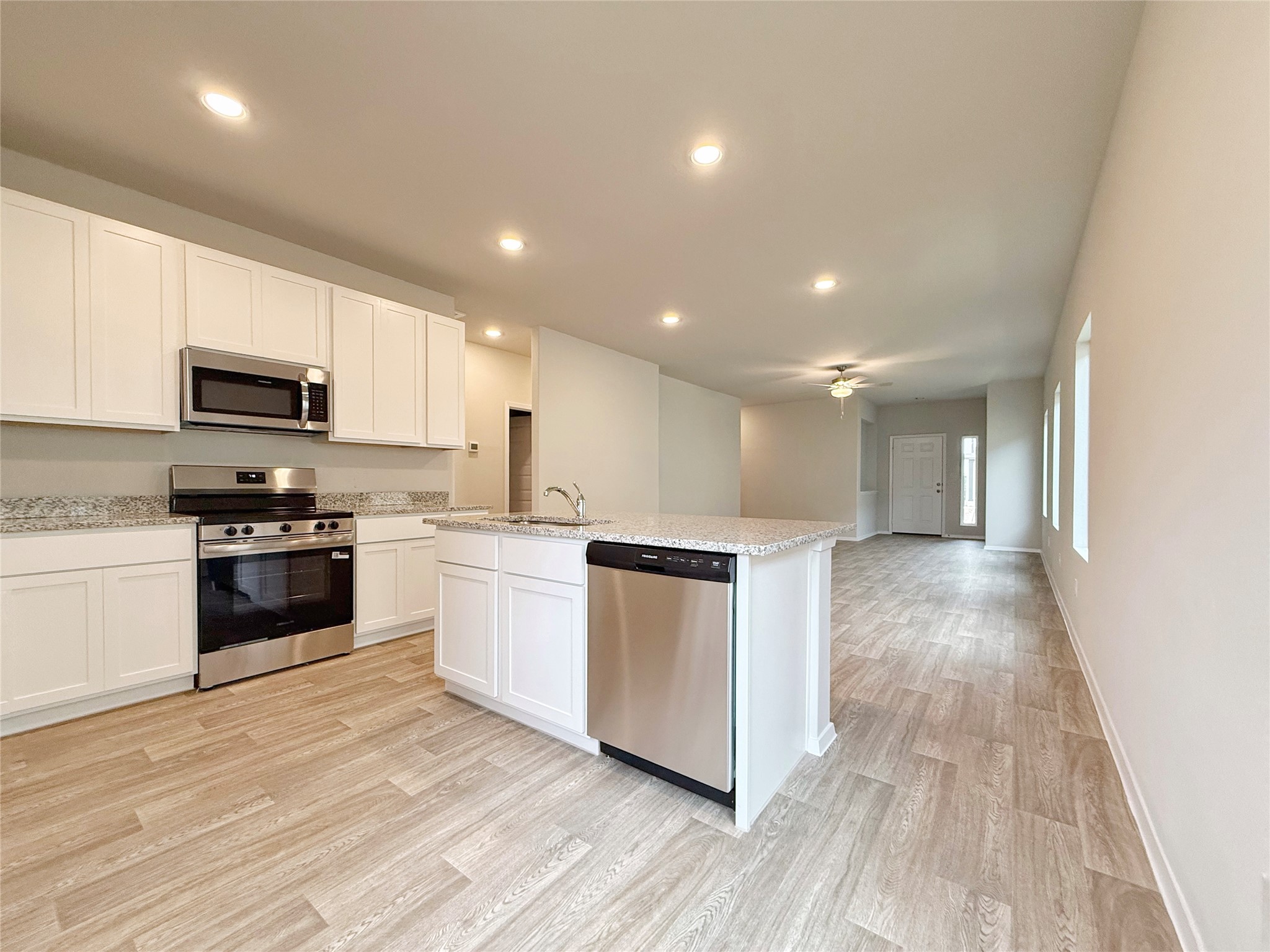 2714 Towy Road Manor, TX 78653 - Photo 6 of 22 A well-lit kitchen with sleek stainless steel appliances and an inviting open-concept layout.