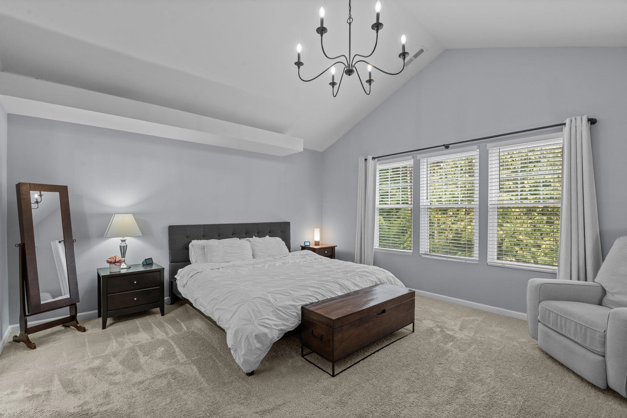 7718 Cape Charles Drive Raleigh, NC 27617 - Photo 20 of 43 a spacious bedroom with a bed a couch and dresser
