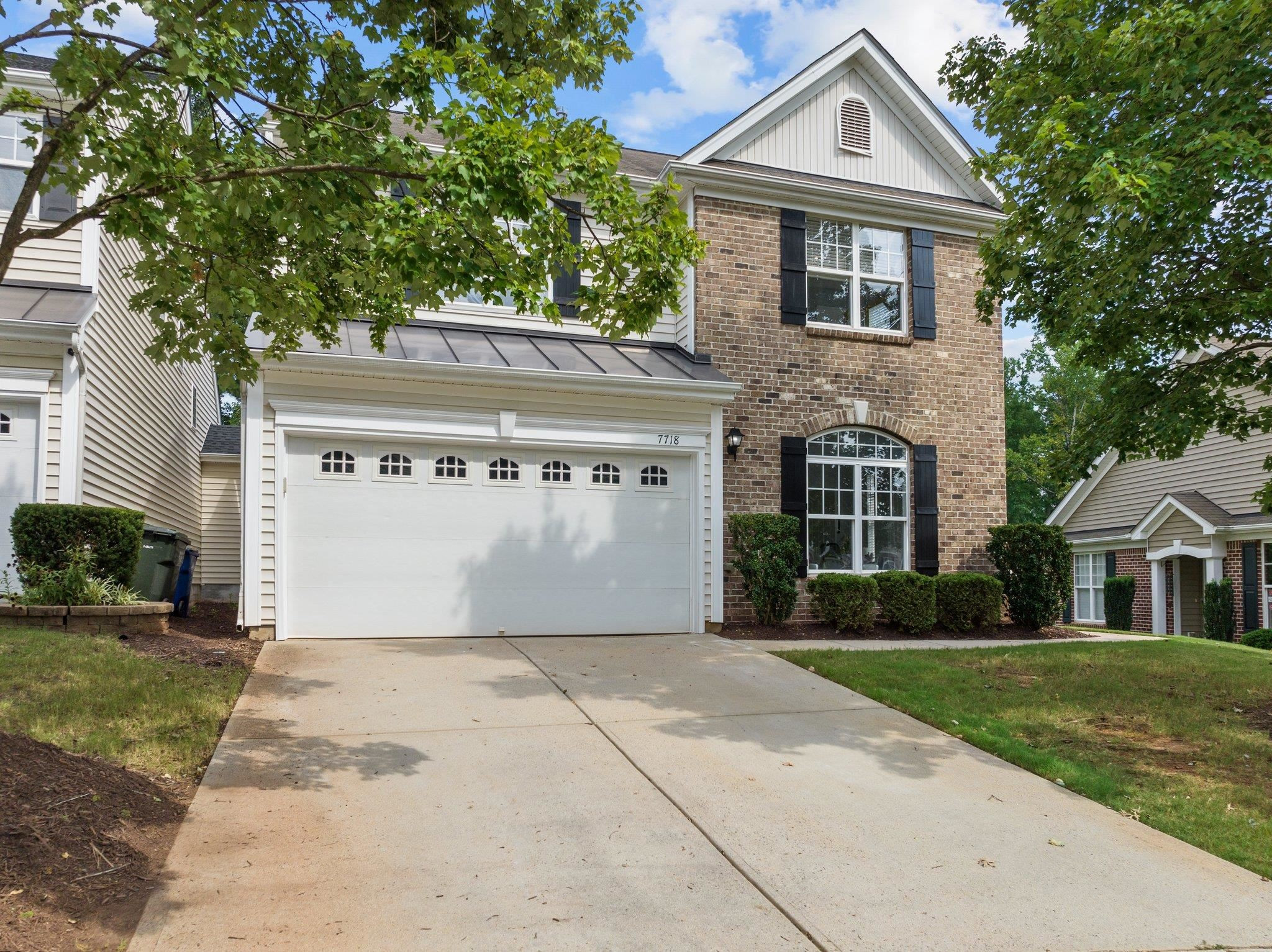 7718 Cape Charles Drive Raleigh, NC 27617 - Photo 2 of 43 a front view of a house with a yard and garage