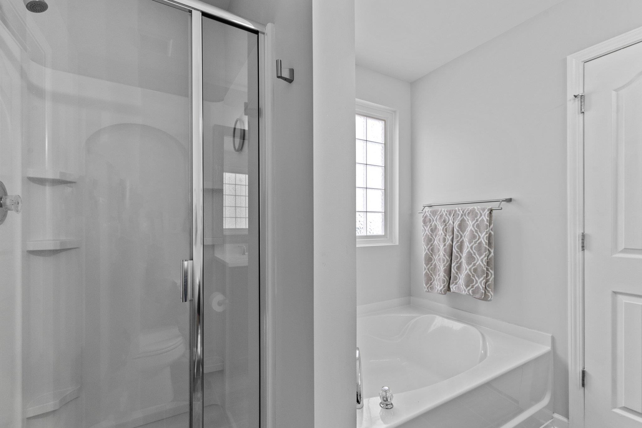 7718 Cape Charles Drive Raleigh, NC 27617 - Photo 25 of 43 a bathroom with a bathtub and shower
