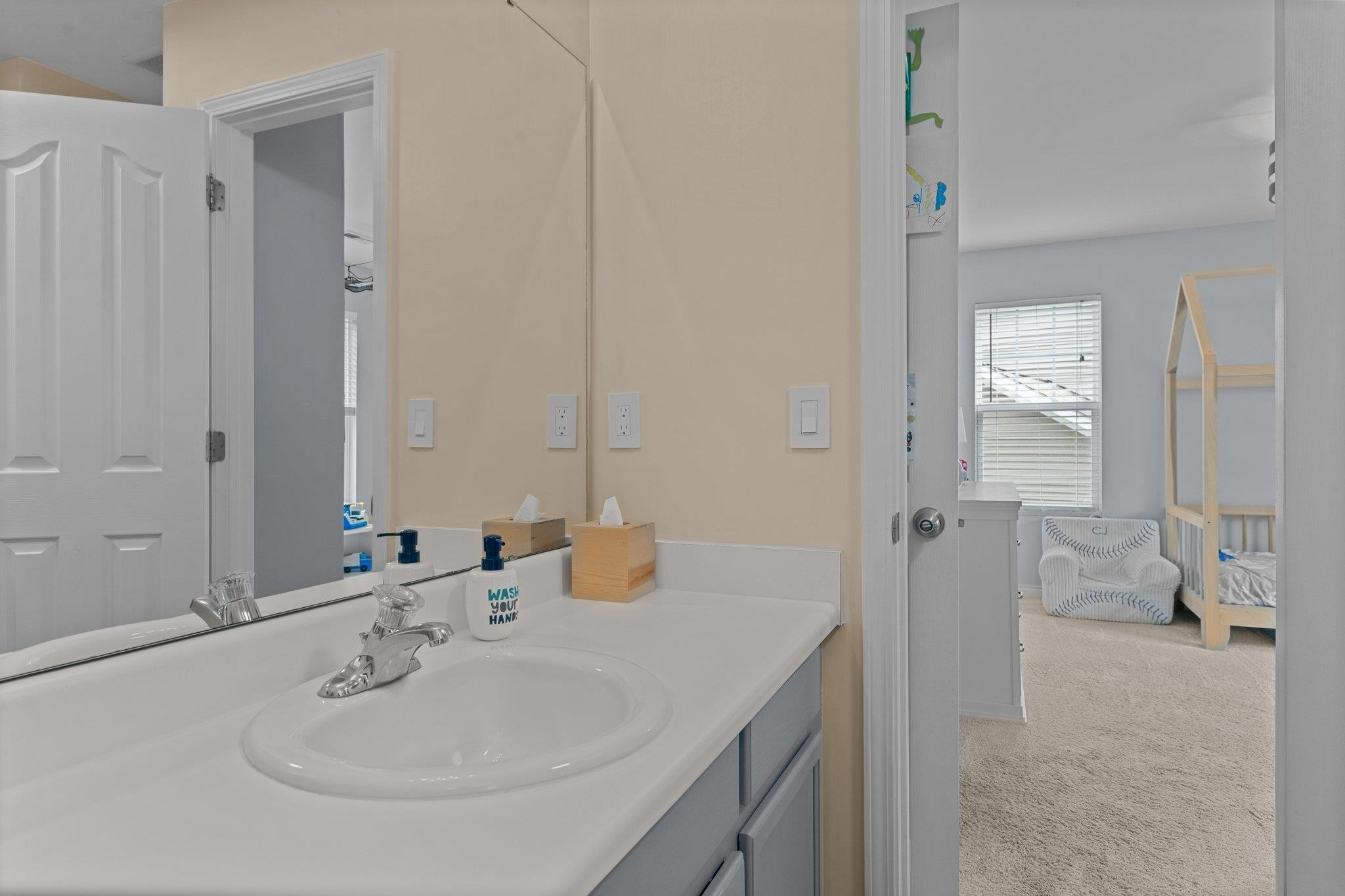 7718 Cape Charles Drive Raleigh, NC 27617 - Photo 28 of 43 a bathroom with a sink and a mirror