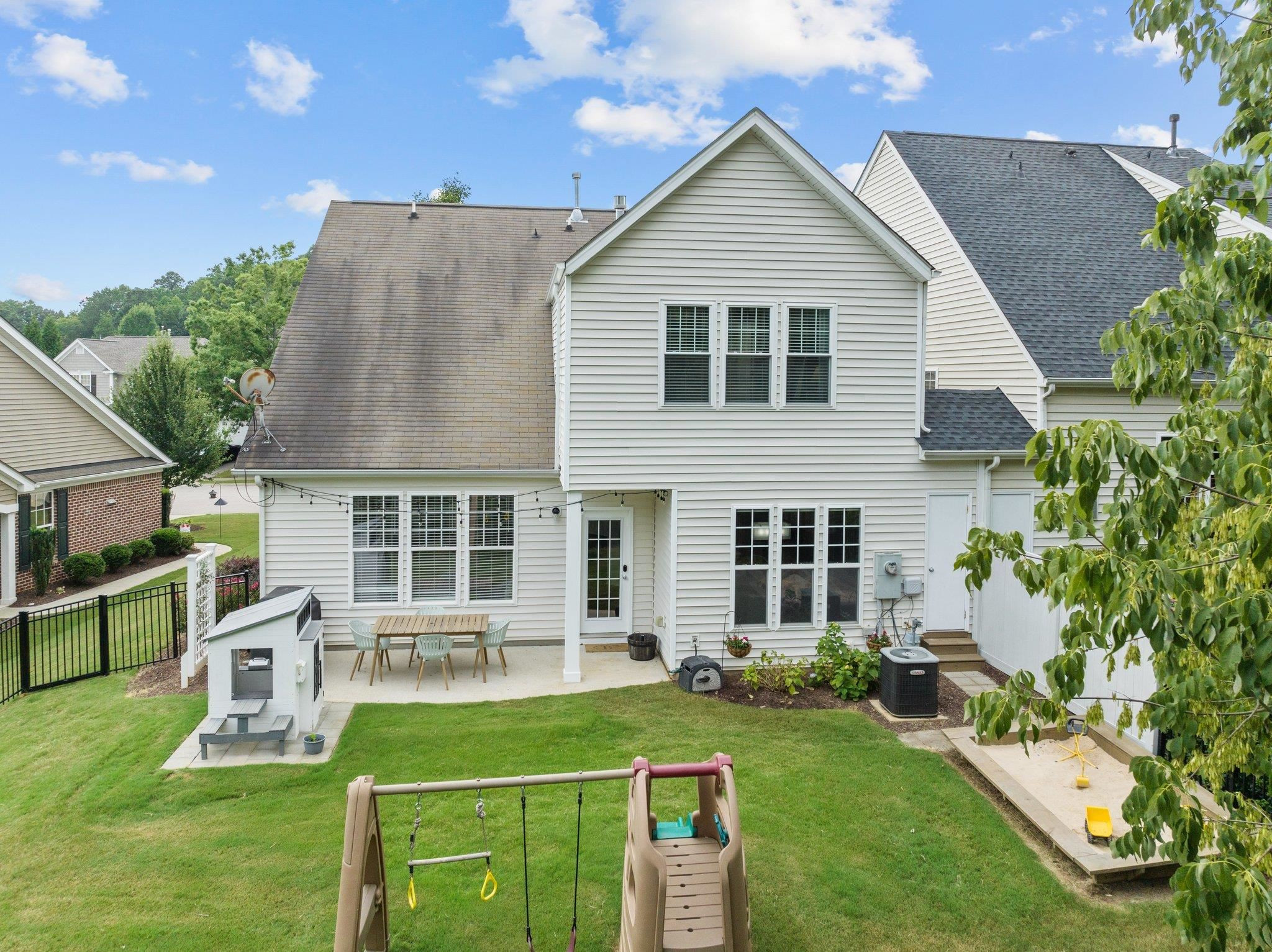 7718 Cape Charles Drive Raleigh, NC 27617 - Photo 32 of 43 a front view of a house with a yard table and chairs