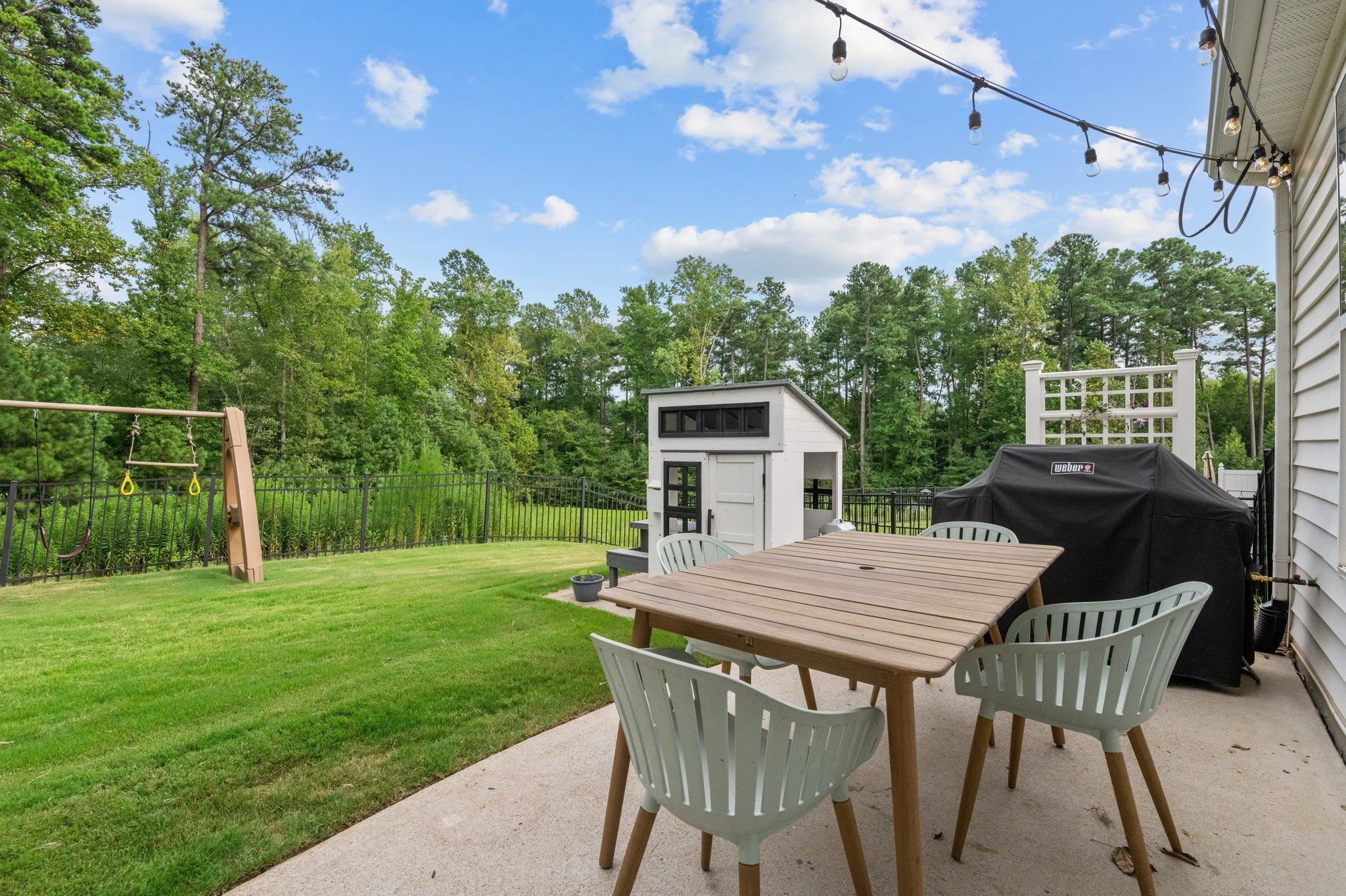 7718 Cape Charles Drive Raleigh, NC 27617 - Photo 35 of 43 a view of a patio with table and chairs with wooden floor and fence
