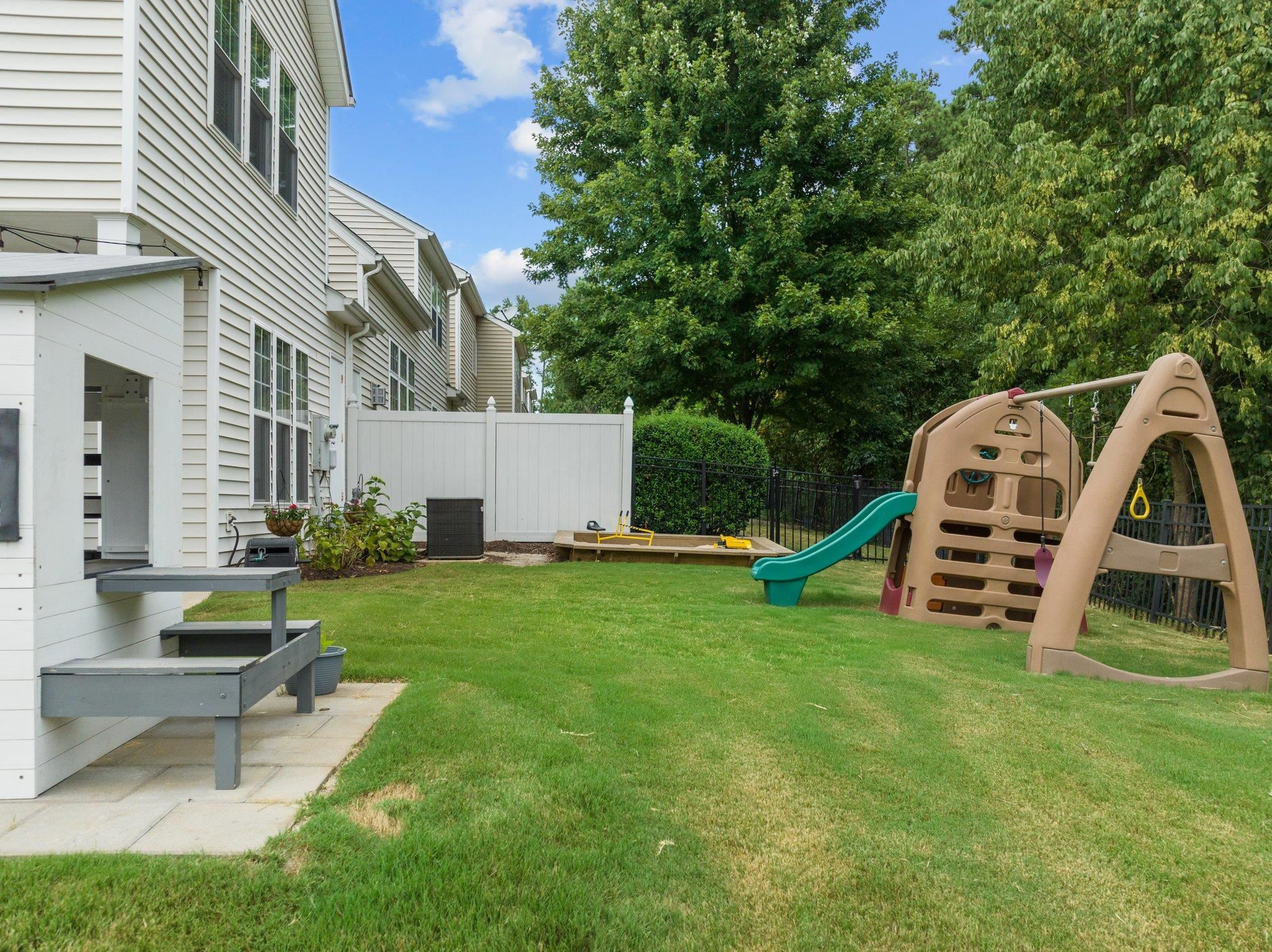 7718 Cape Charles Drive Raleigh, NC 27617 - Photo 36 of 43 a view of a house with a backyard and a slide