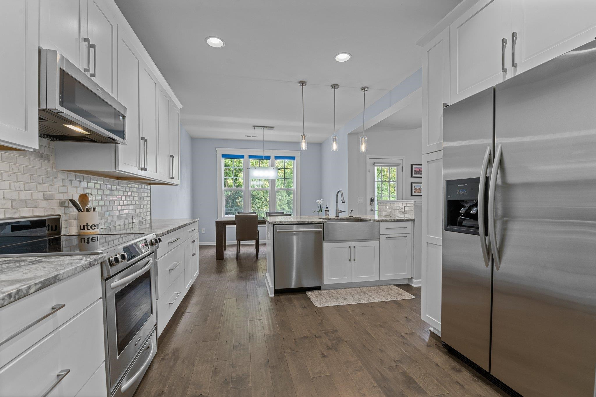 7718 Cape Charles Drive Raleigh, NC 27617 - Photo 5 of 43 a kitchen with a sink stainless steel appliances and cabinets