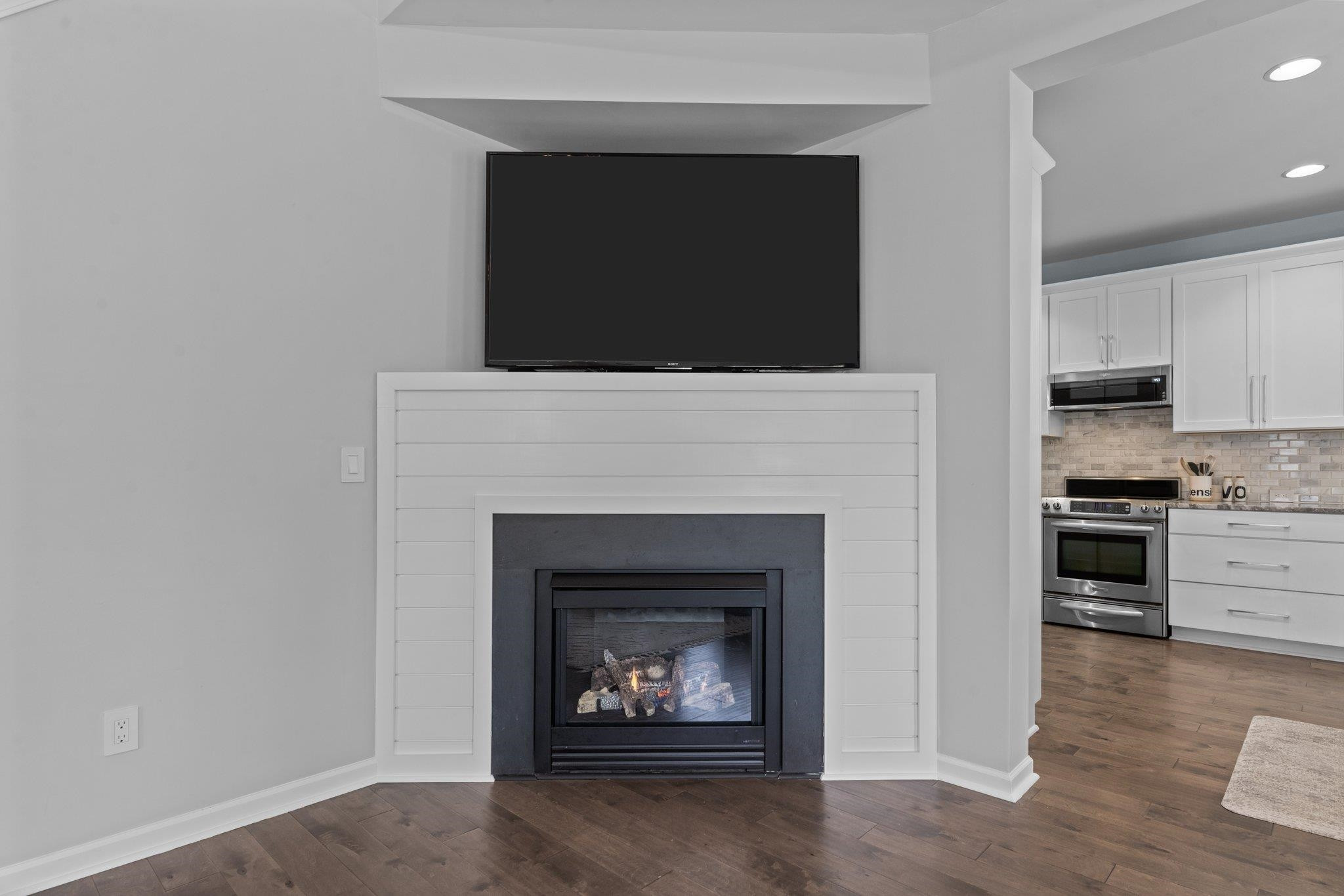 7718 Cape Charles Drive Raleigh, NC 27617 - Photo 10 of 43 a living room with furniture and a fireplace