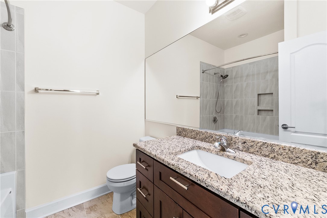 15430 River Road Chesterfield, VA 23838 - Photo 29 of 46 a bathroom with a granite countertop sink a toilet and a mirror