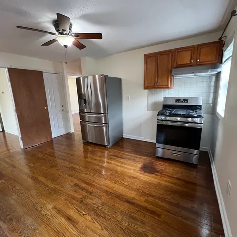 a kitchen with stainless steel appliances a stove a refrigerator and a microwave