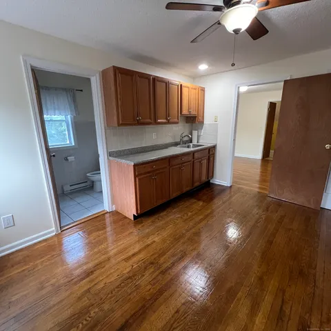 a large room with a kitchen view