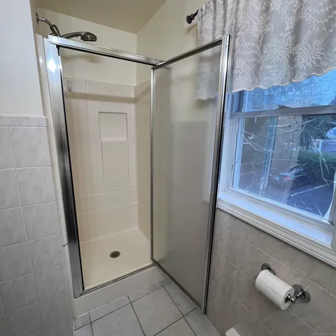 a bathroom with a glass shower door