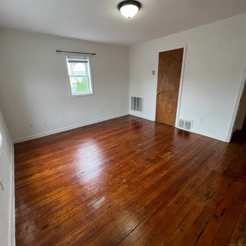 a view of walk in closet with wooden floor and cabinet