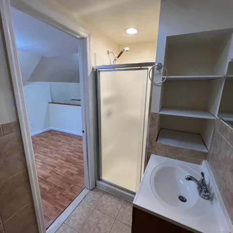 a view of a livingroom with an empty space and wooden floor