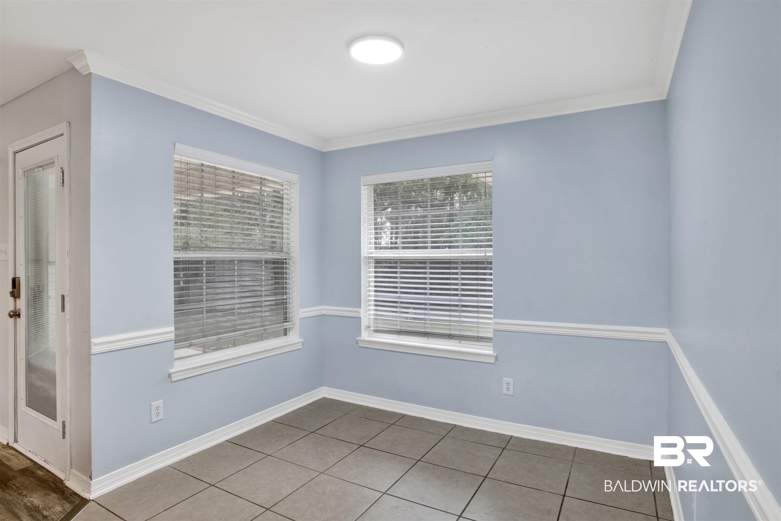 9534 Labrador Run North Mobile, AL 36695 - Photo 10 of 30 Spare room featuring light tile patterned floors and crown molding