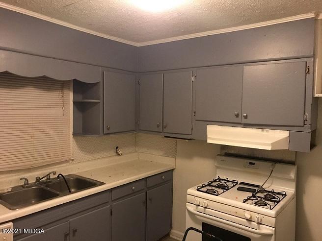 3839 Mathis Street Macon, GA 31206 - Photo 3 of 3 a kitchen with a sink and a stove top oven