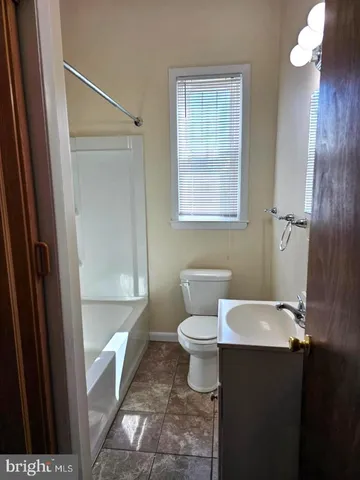 a bathroom with a toilet a sink and a shower