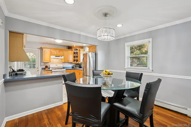 a view of a dining room with furniture wooden floor and chandelier